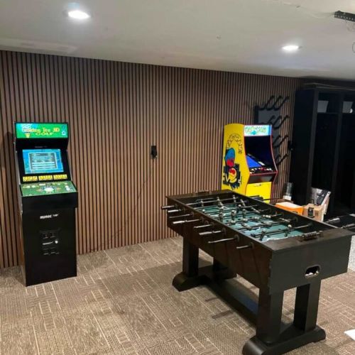 Garage game room conversion. Golden Tee, Pacman, Foosball, Gym with dumb bells & bench as well as a wall mounted skit boot heater. Garage is partially finished and has no HVAC